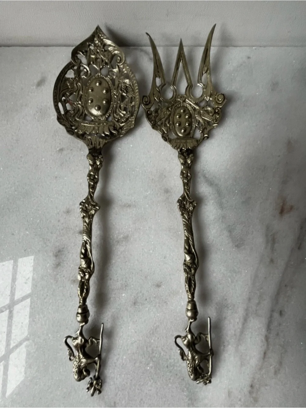 vintage Italian serving utensils are an ornate brass fork and spoon set